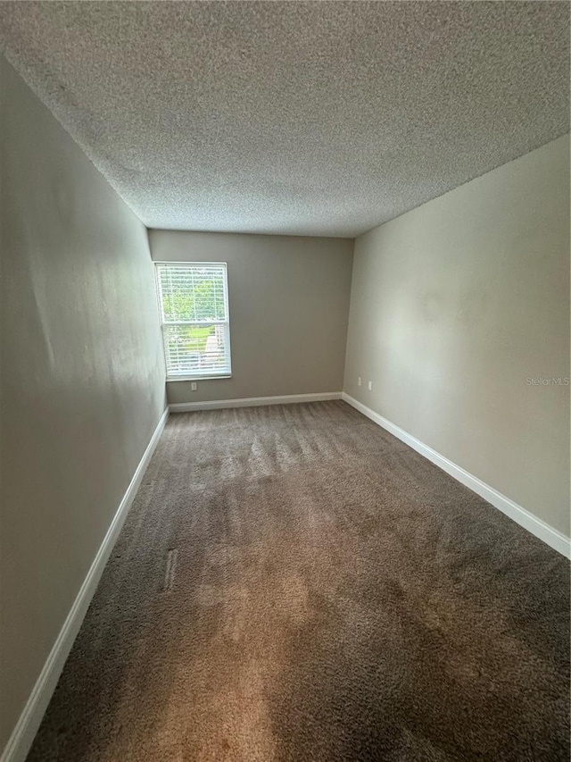 carpeted spare room with a textured ceiling