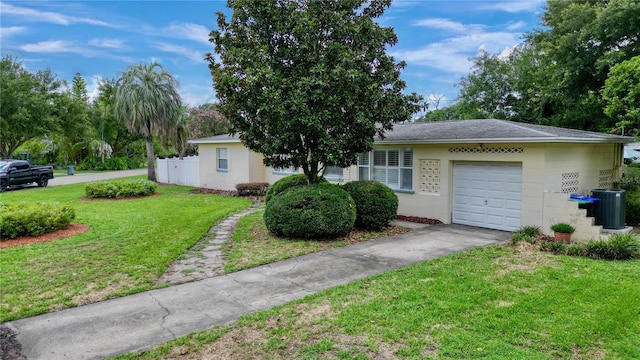 single story home with a front lawn, a garage, and central AC unit