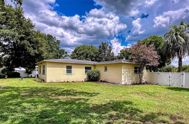 rear view of house with a lawn