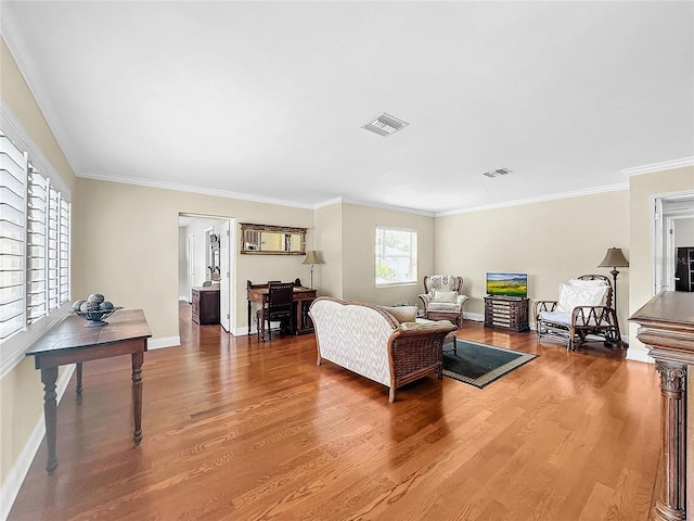 living room with hardwood / wood-style floors and ornamental molding