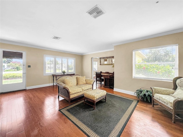 living room with wood-type flooring and ornamental molding