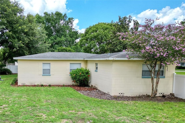 view of side of property with a yard