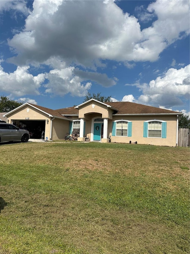 single story home with a garage and a front lawn