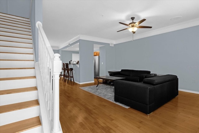 living room with ceiling fan, hardwood / wood-style floors, and crown molding