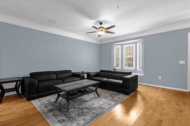 living room with hardwood / wood-style flooring, ceiling fan, and crown molding