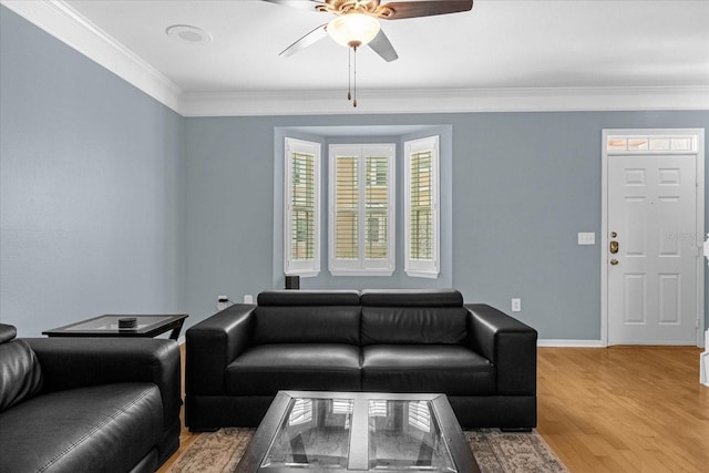 living room with wood-type flooring, ceiling fan, and ornamental molding