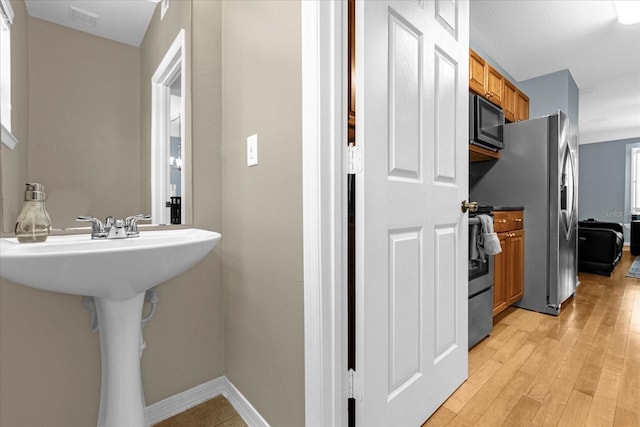 bathroom with hardwood / wood-style flooring