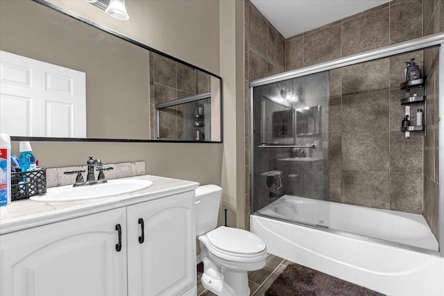 full bathroom with vanity, toilet, and bath / shower combo with glass door