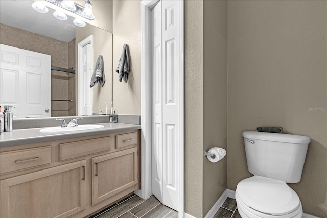 bathroom with hardwood / wood-style floors, vanity, and toilet