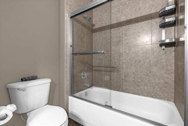 bathroom with toilet and enclosed tub / shower combo