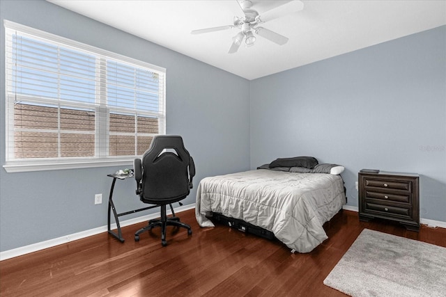 bedroom with ceiling fan and dark hardwood / wood-style floors