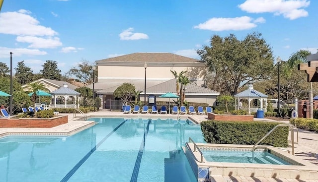 view of swimming pool featuring a gazebo and a community hot tub