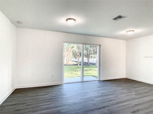 unfurnished room with dark hardwood / wood-style flooring