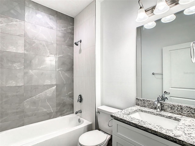 full bathroom featuring vanity, toilet, and tiled shower / bath