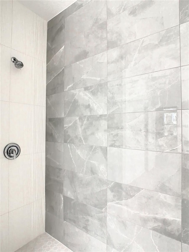 bathroom with a tile shower