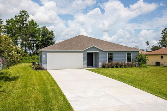 single story home featuring a garage, cooling unit, and a front lawn