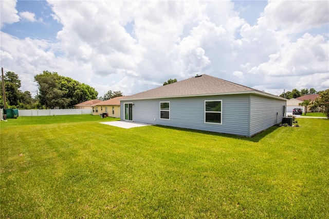 rear view of property featuring a lawn and a patio