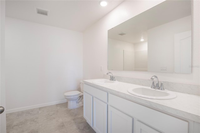 bathroom featuring toilet and vanity