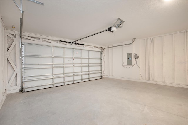 garage with a garage door opener and electric panel