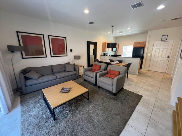 living room featuring light tile floors