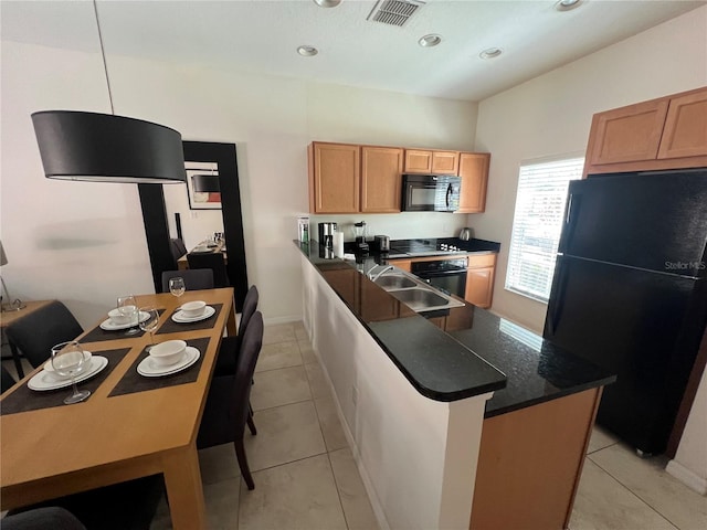 kitchen featuring pendant lighting, sink, black appliances, and light tile floors