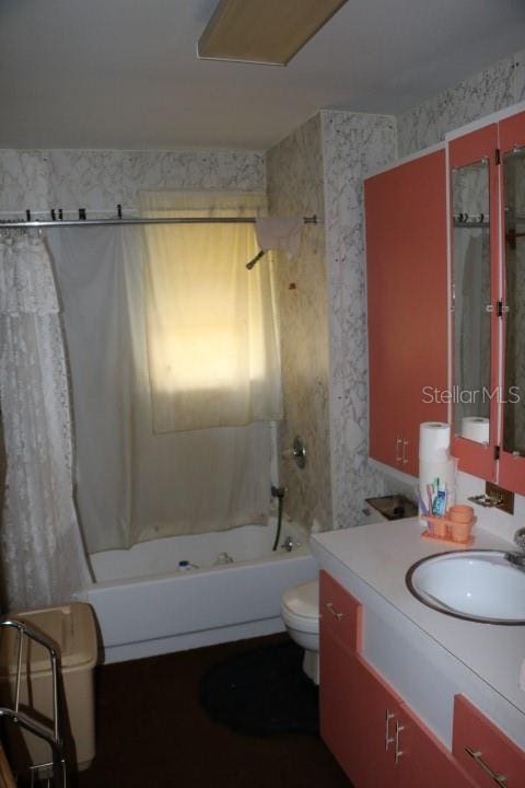 full bathroom with vanity, shower / bath combination with curtain, and toilet