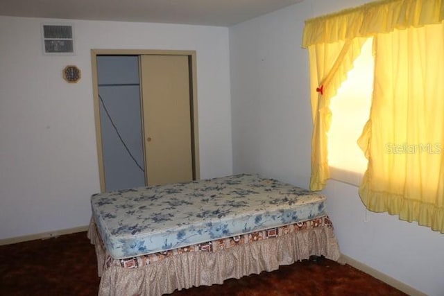 carpeted bedroom featuring a closet