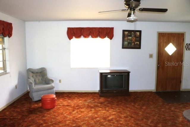 sitting room featuring ceiling fan and a wealth of natural light