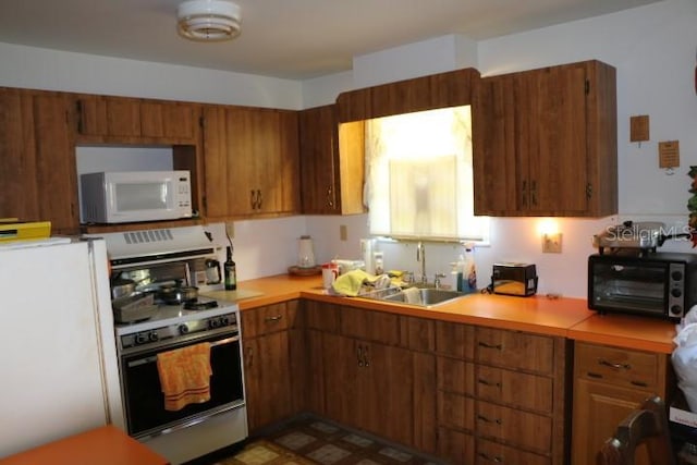 kitchen with sink and white appliances