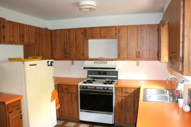 kitchen featuring white appliances and sink