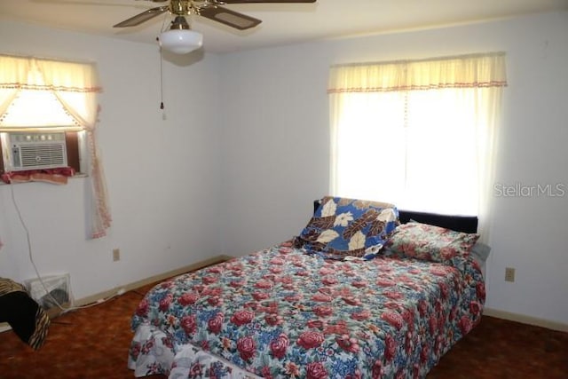 carpeted bedroom with ceiling fan and cooling unit