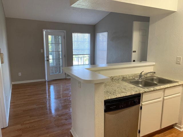 kitchen featuring lofted ceiling, kitchen peninsula, stainless steel dishwasher, dark hardwood / wood-style flooring, and white cabinetry