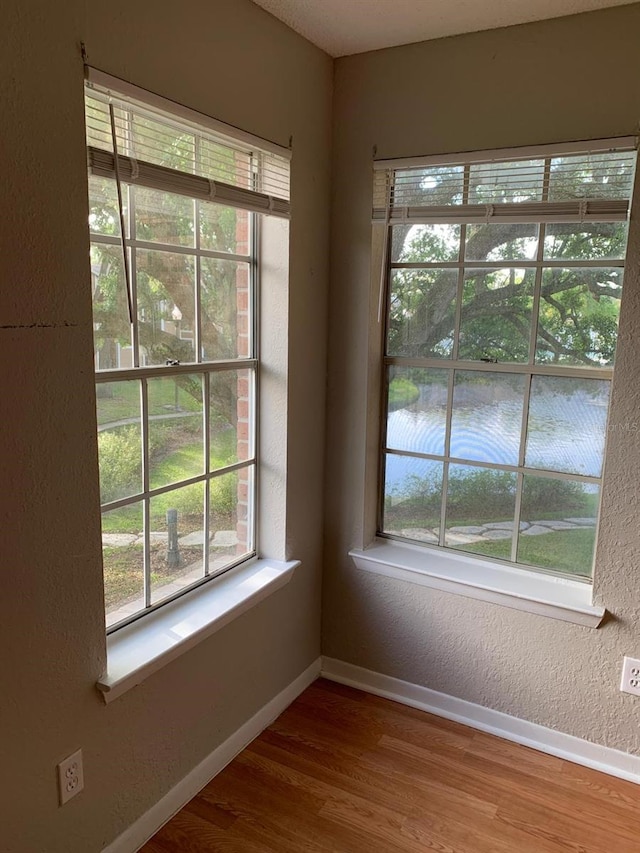 interior space featuring hardwood / wood-style floors and a water view