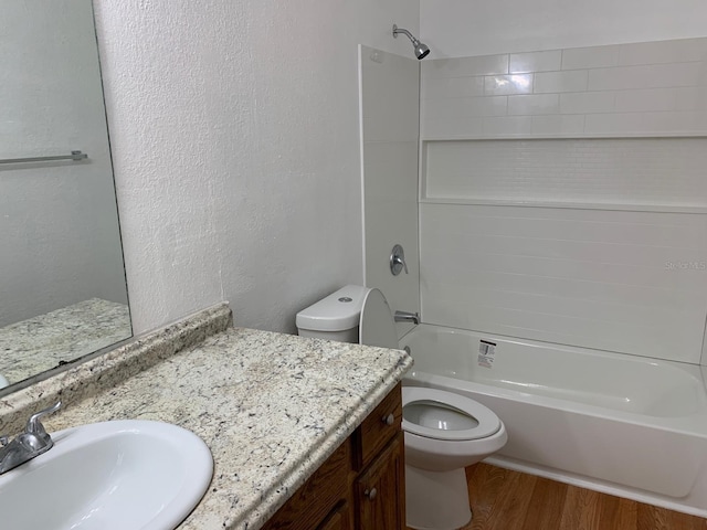 full bathroom featuring hardwood / wood-style floors, vanity, toilet, and shower / washtub combination