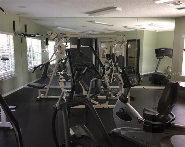 workout area featuring a textured ceiling