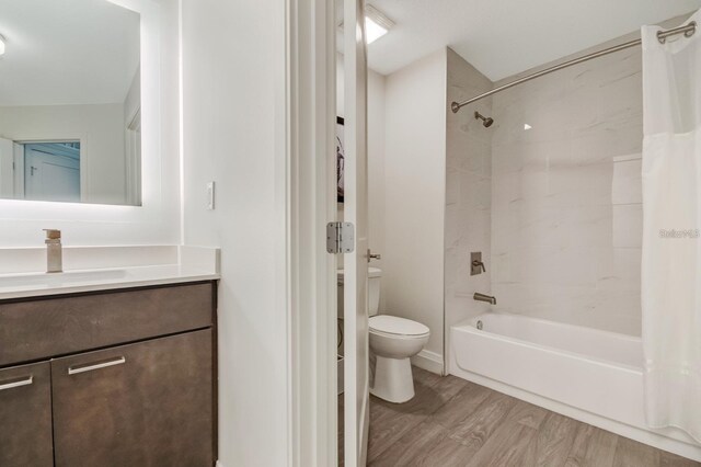 full bathroom featuring shower / bath combination with curtain, vanity, toilet, and wood-type flooring