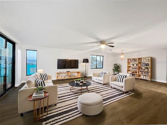 living area featuring ceiling fan, wood finished floors, and baseboards