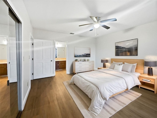 bedroom featuring ceiling fan, ensuite bath, wood finished floors, and visible vents