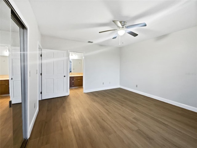 unfurnished bedroom with visible vents, dark wood finished floors, and baseboards