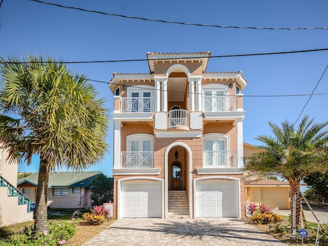 view of front of home with a garage and a balcony