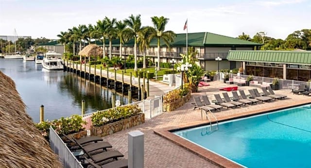 view of swimming pool featuring a water view