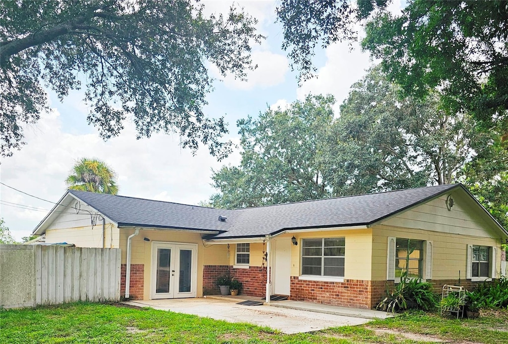 back of house with a yard, a patio area, and french doors