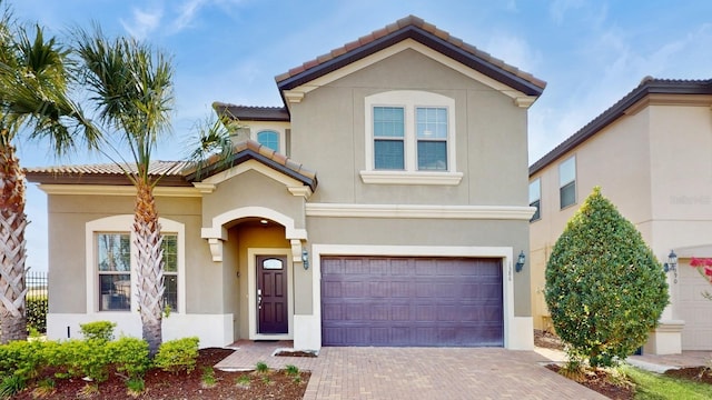 mediterranean / spanish-style home with a garage