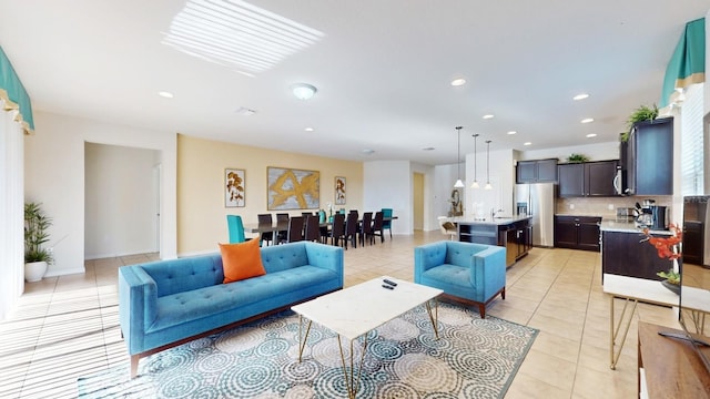 living room featuring sink and light tile floors