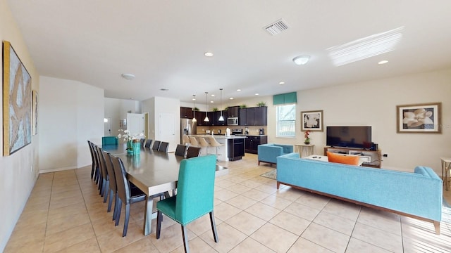 dining area with light tile patterned floors, visible vents, and recessed lighting