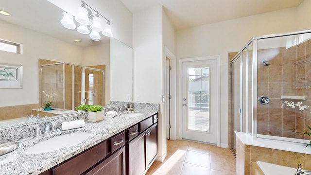 bathroom with double vanity, plenty of natural light, and plus walk in shower