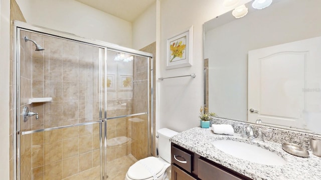 bathroom featuring an enclosed shower, vanity, and toilet