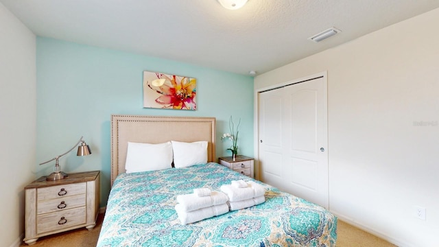 carpeted bedroom with a closet