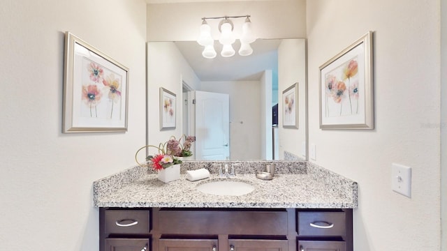 bathroom featuring an inviting chandelier and vanity