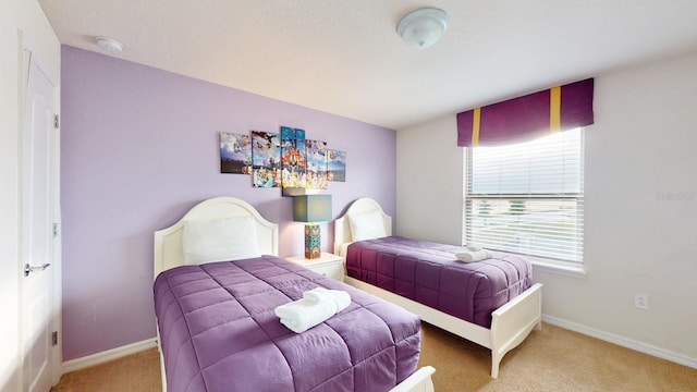 carpeted bedroom featuring baseboards